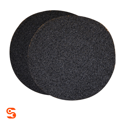 Two round black textured oil drain splash pads with overlapping edges on a white background