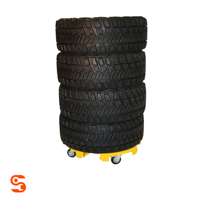 Stack of four black tires on a yellow wheeled tire transport dolly